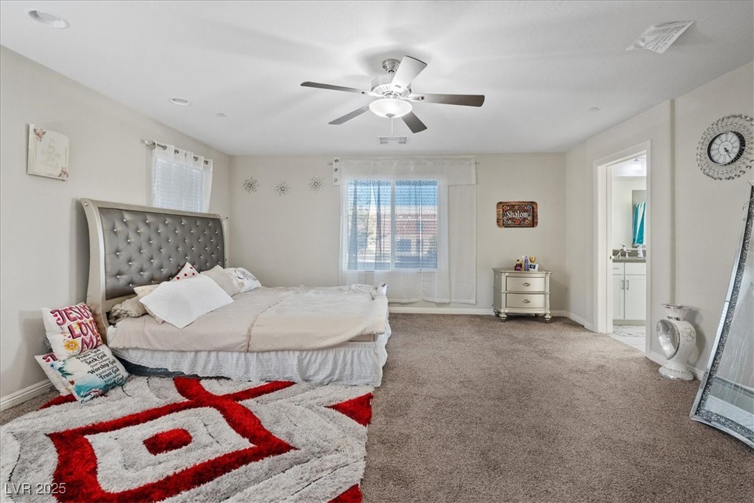 936 Keesey Way Henderson, NV 89052 - Photo 15 of 30 Carpeted bedroom featuring a ceiling fan and connected bathroom