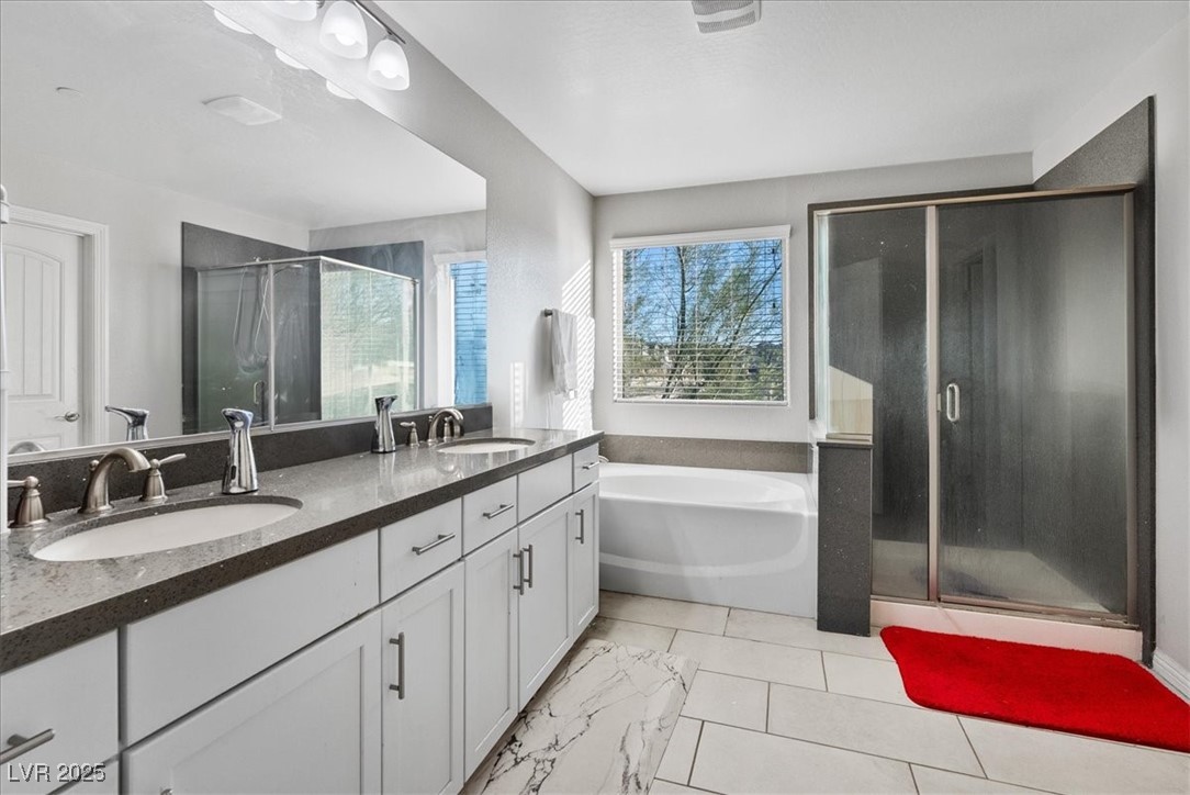 936 Keesey Way Henderson, NV 89052 - Photo 17 of 30 Bathroom with a stall shower, double vanity, and a bath