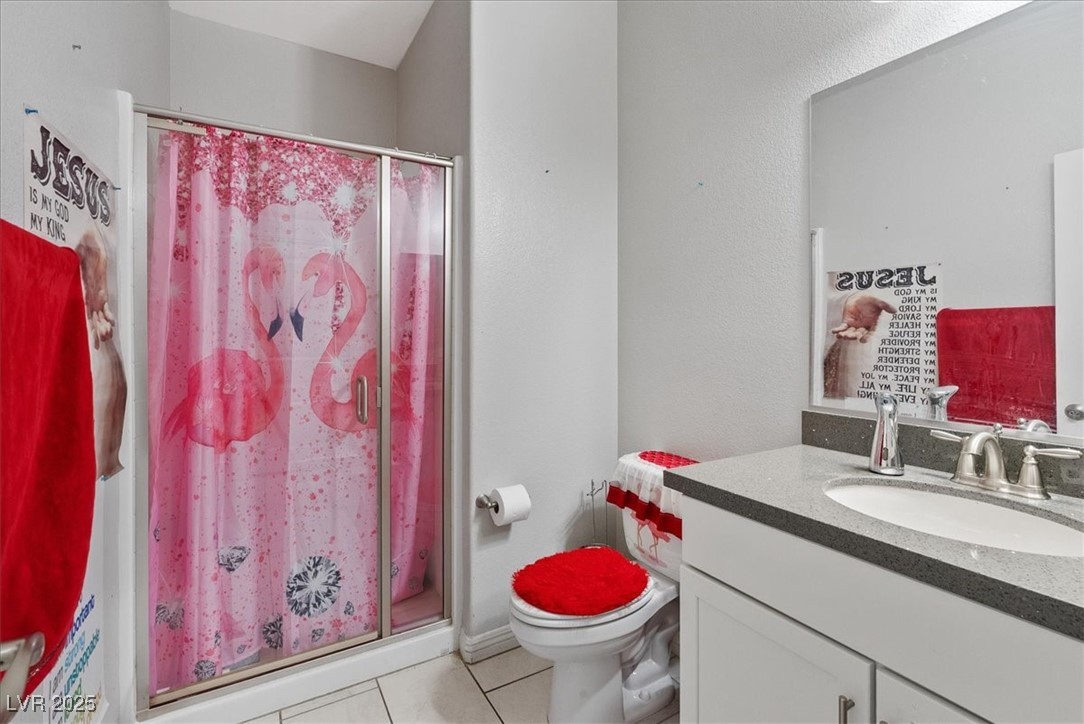 936 Keesey Way Henderson, NV 89052 - Photo 25 of 30 Bathroom featuring light tile patterned floors, vanity, a stall shower, and a textured wall