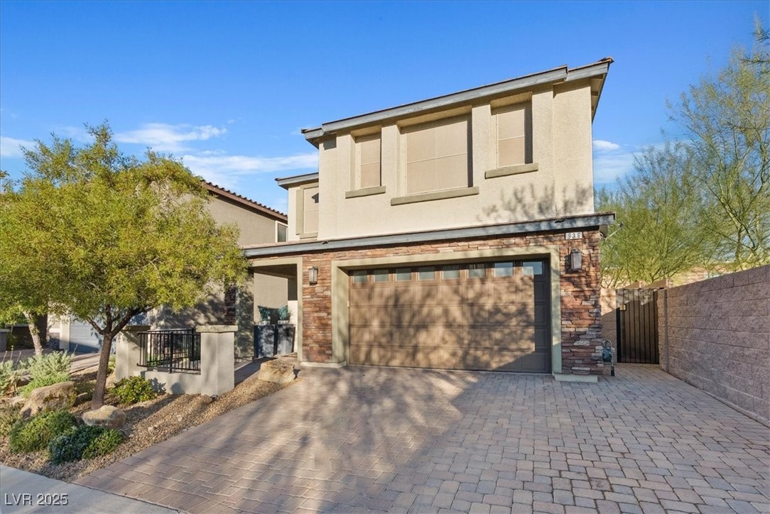 936 Keesey Way Henderson, NV 89052 - Photo 3 of 30 Mediterranean / spanish-style house featuring stucco siding, a garage, decorative driveway, and a patio area