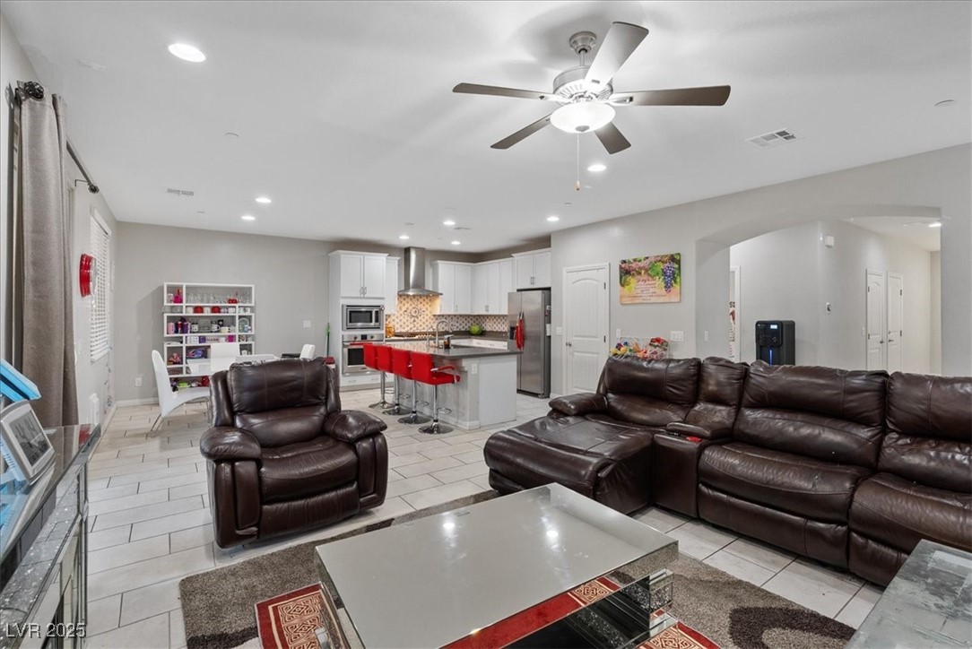936 Keesey Way Henderson, NV 89052 - Photo 9 of 30 Living area with recessed lighting, light tile patterned floors, arched walkways, and ceiling fan