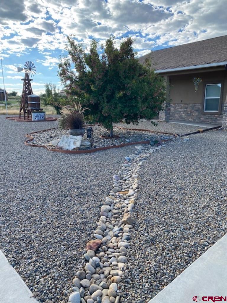 1941 Kaleigh Circle Cortez, CO 81321 - Photo 12 of 35 a view of a yard with a tree
