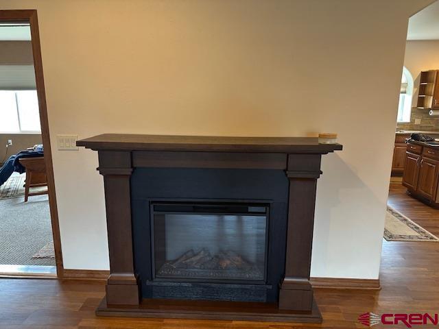 1941 Kaleigh Circle Cortez, CO 81321 - Photo 21 of 35 a living room with a fireplace and a wooden floor