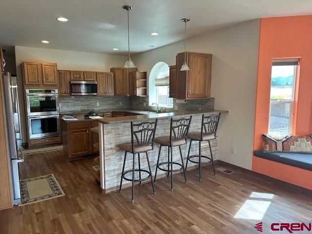1941 Kaleigh Circle Cortez, CO 81321 - Photo 26 of 35 a kitchen with stainless steel appliances granite countertop wooden floor window and cabinets