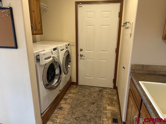 1941 Kaleigh Circle Cortez, CO 81321 - Photo 32 of 35 a view of a storage and utility room with a washer dryer