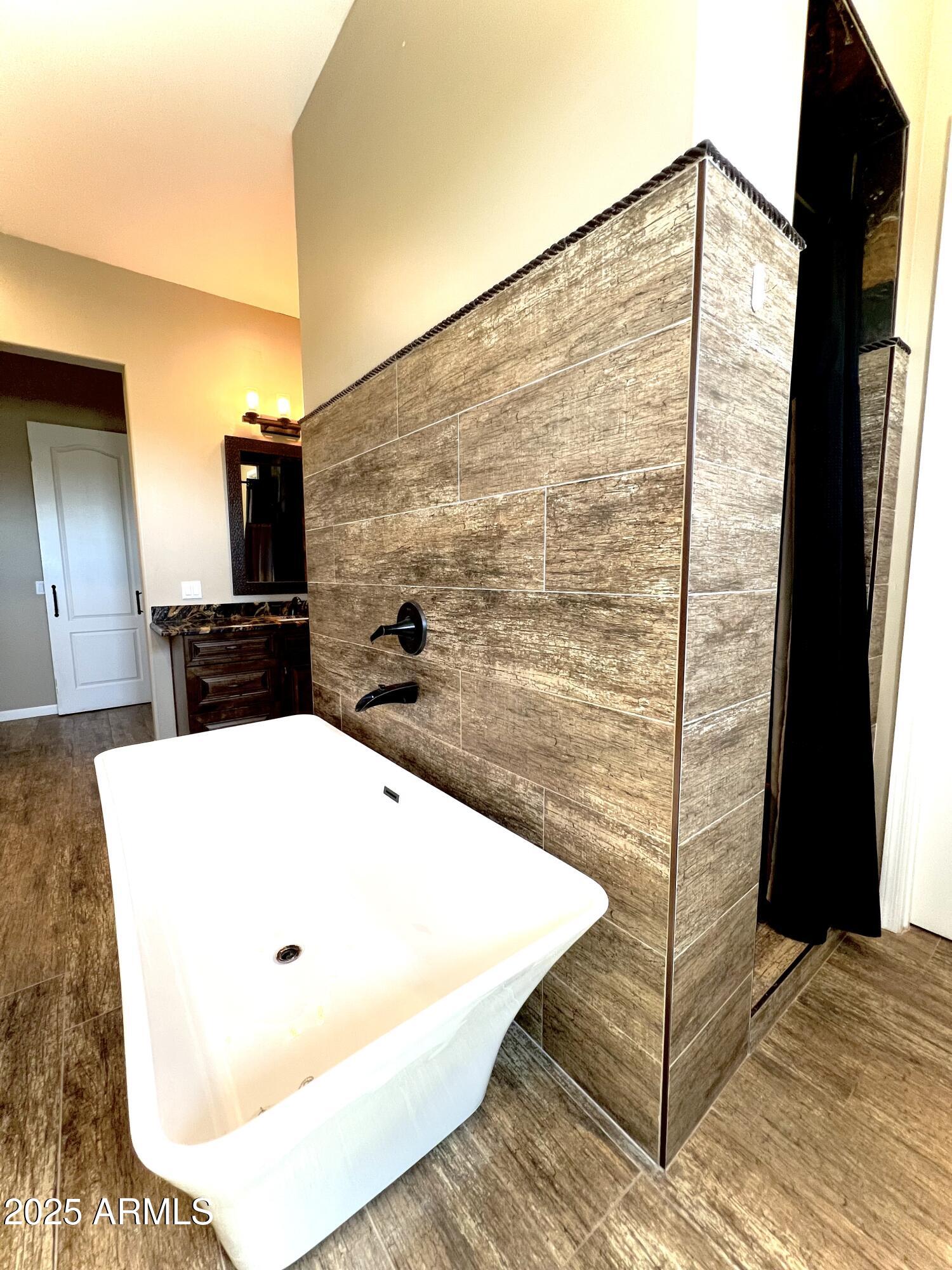 15035 East Countryside Road Mayer, AZ 86333 - Photo 13 of 37 a bathroom with a bathtub and a shower