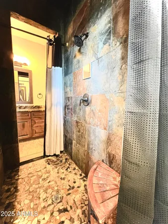 a bathroom with a granite countertop shower and a sink