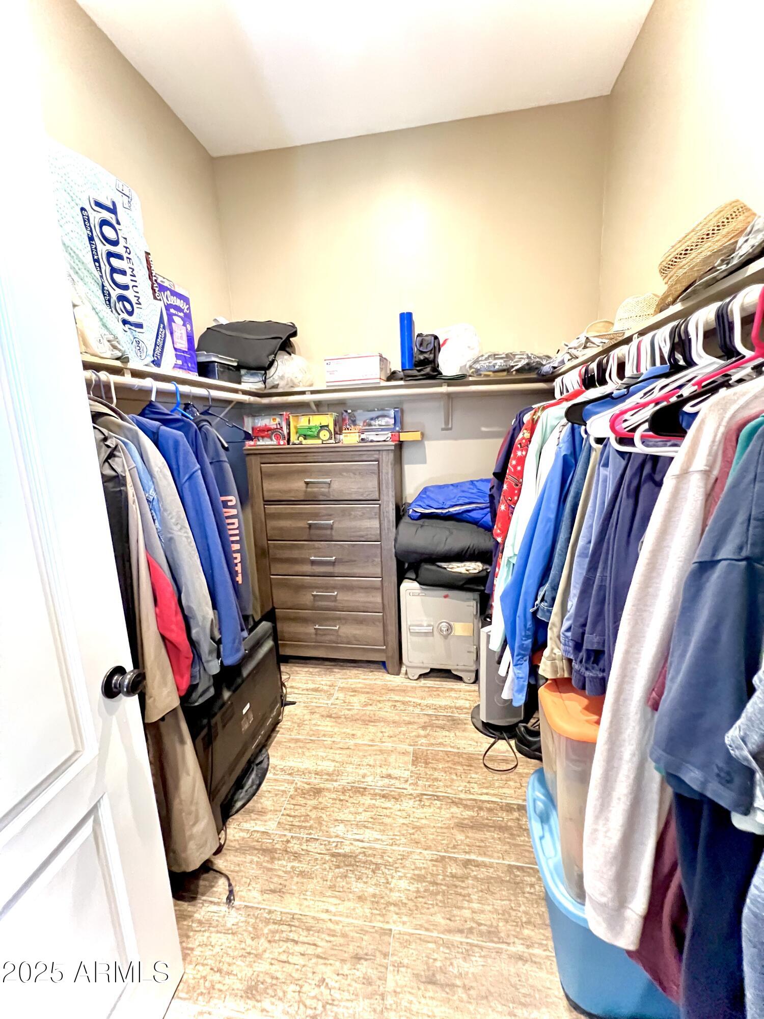 15035 East Countryside Road Mayer, AZ 86333 - Photo 19 of 37 a view of walk in closet with clothes and shoes