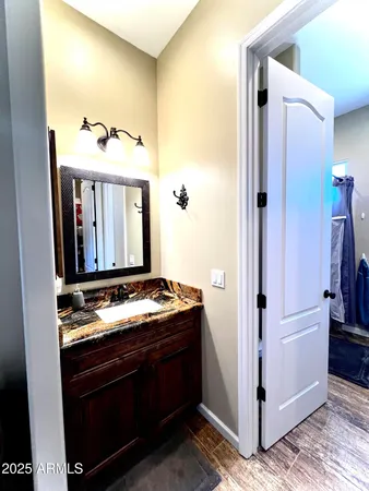 a bathroom with a granite countertop sink and a mirror