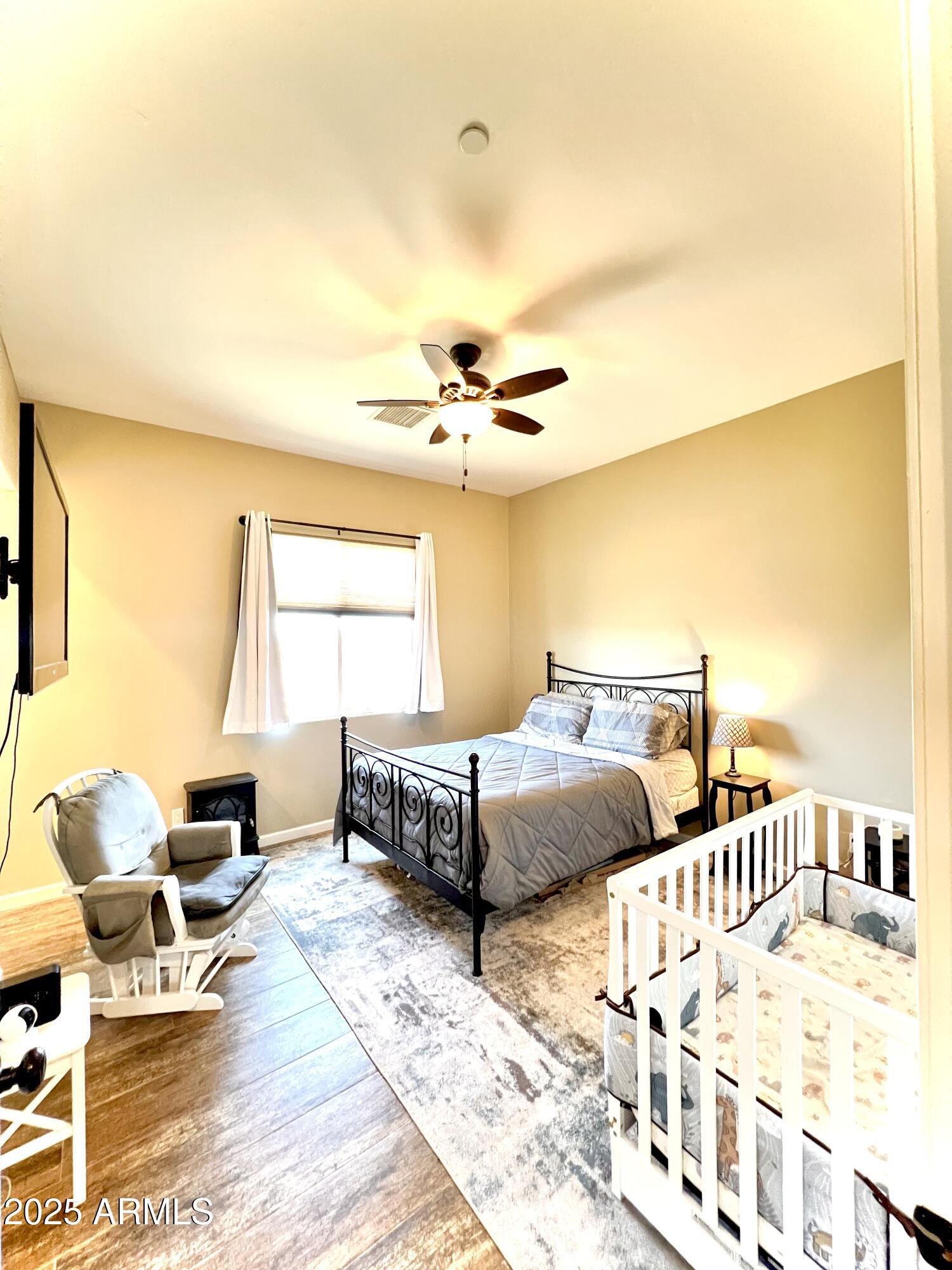 15035 East Countryside Road Mayer, AZ 86333 - Photo 30 of 37 a bedroom with a bed and wooden floor