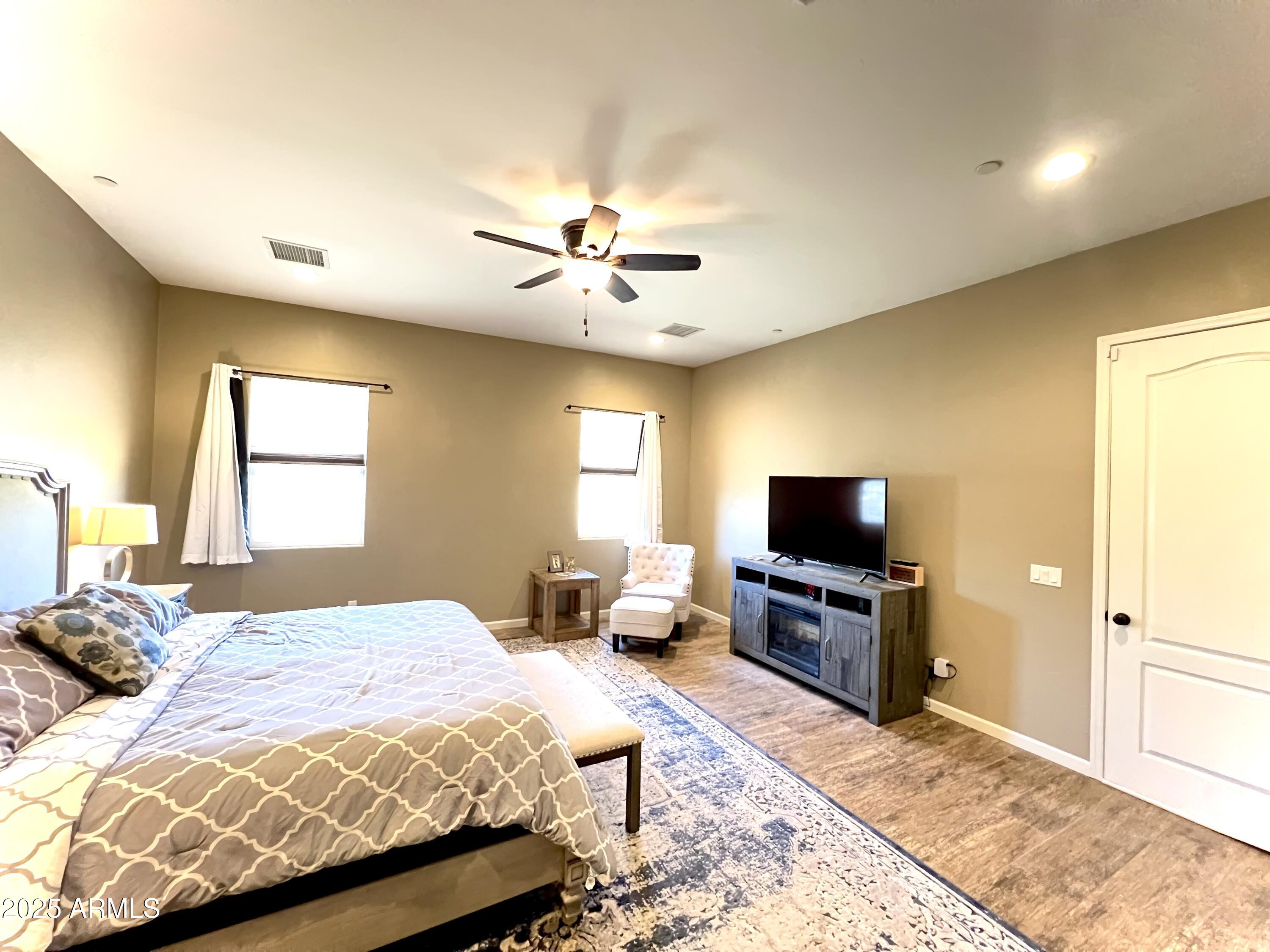 15035 East Countryside Road Mayer, AZ 86333 - Photo 10 of 37 a bedroom with a bed and a flat screen tv