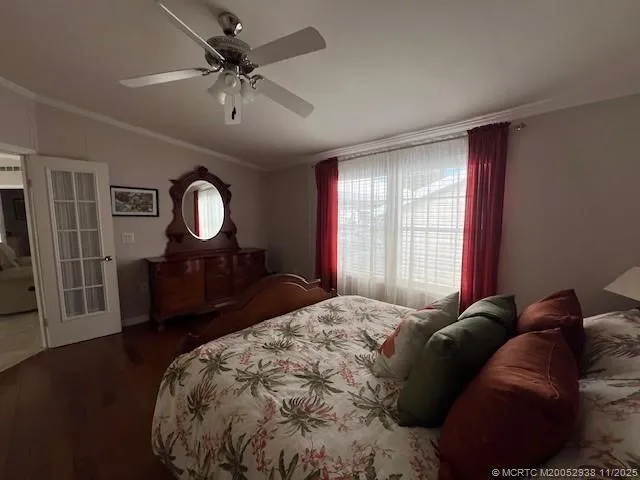 a bed sitting in a spacious bedroom next to a window