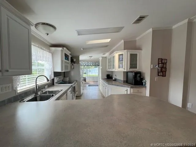 a kitchen with granite countertop a sink and a stove top oven
