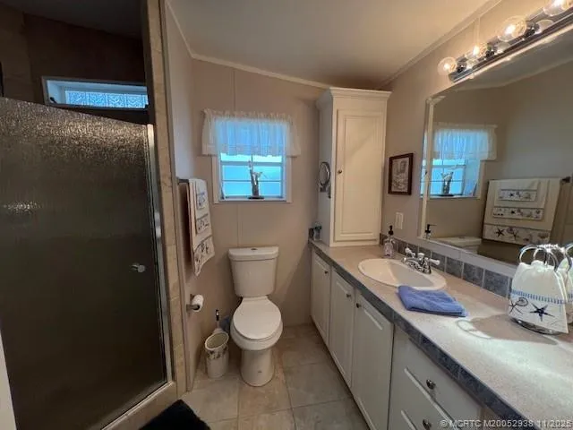 a bathroom with a granite countertop toilet sink and mirror