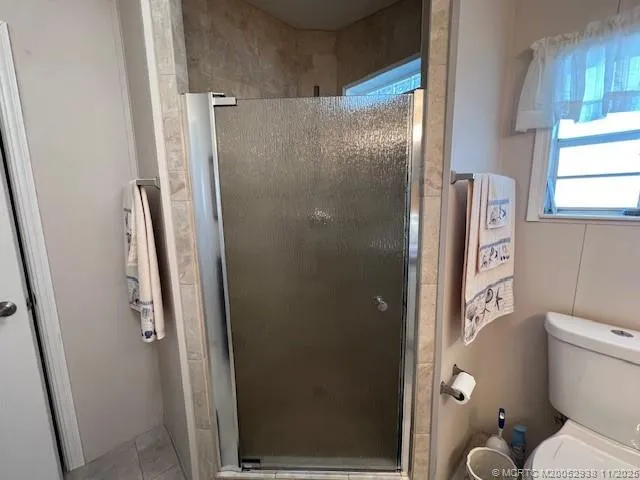 a bathroom with a shower and a toilet