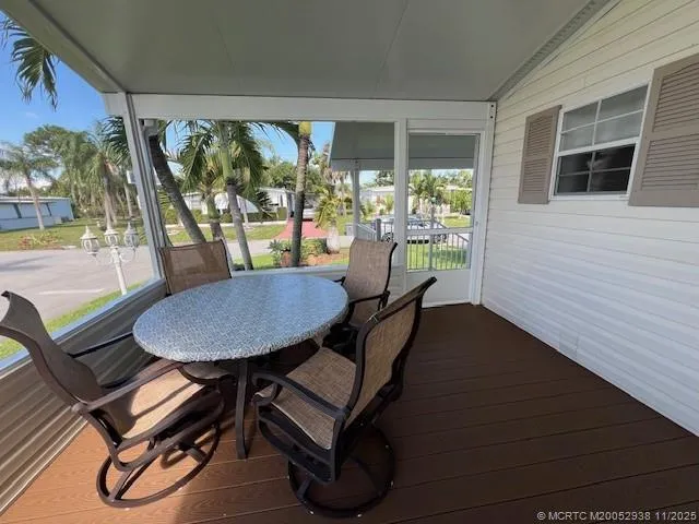 a view of a patio with table and chairs potted plants