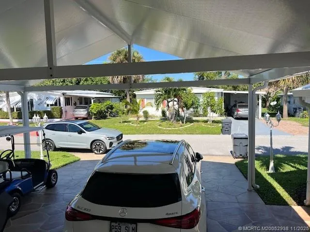 a view of a house with a yard and potted plants