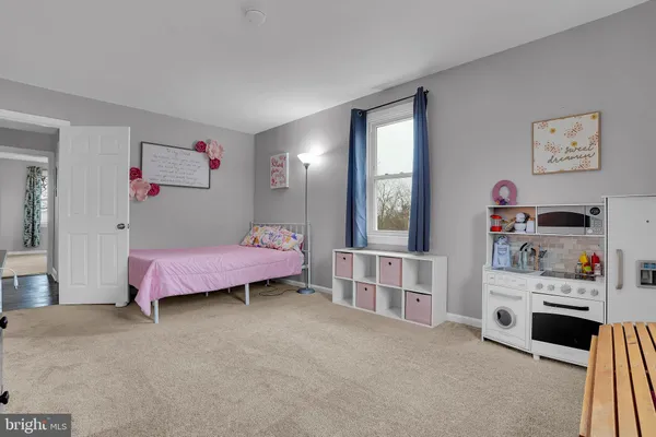 a bedroom with furniture and a baby crib