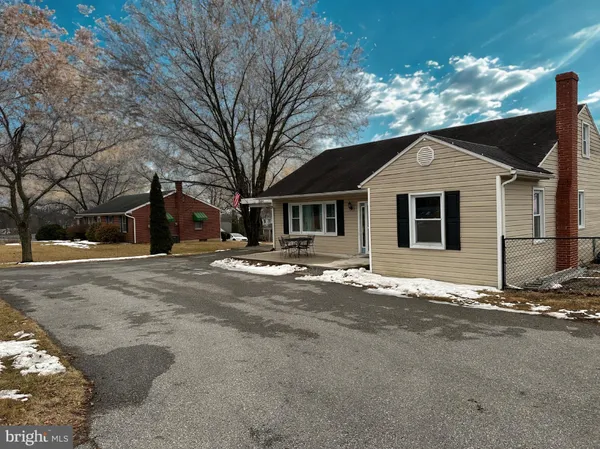a front view of house with yard and trees