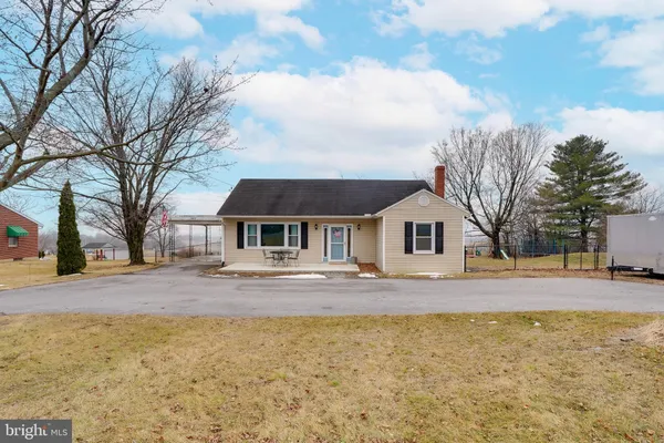 a view of house with outdoor space and sitting area