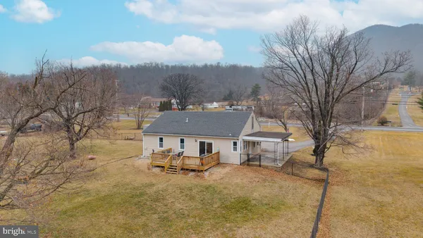a front view of house with yard and trees