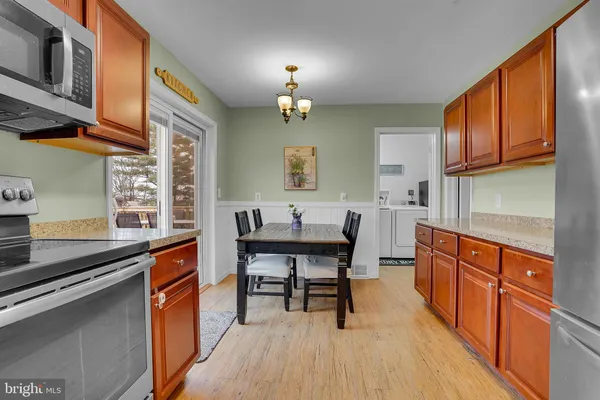 a kitchen with stainless steel appliances granite countertop sink stove top oven and cabinets