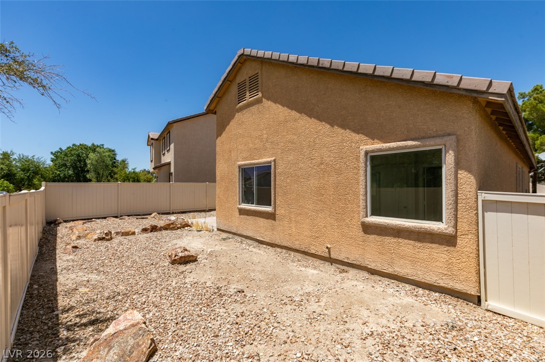 5150 Riverside Run Court North Las Vegas, NV 89081 - Photo 48 of 50 A private, gravel backyard with a sturdy vinyl fence offers a blank canvas for outdoor living.