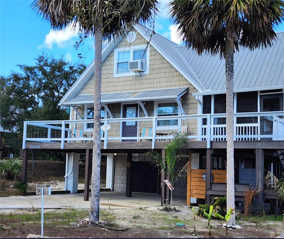 7 Bass Street Panacea, FL 32346 - Photo 2 of 11 a view of a house with a swimming pool