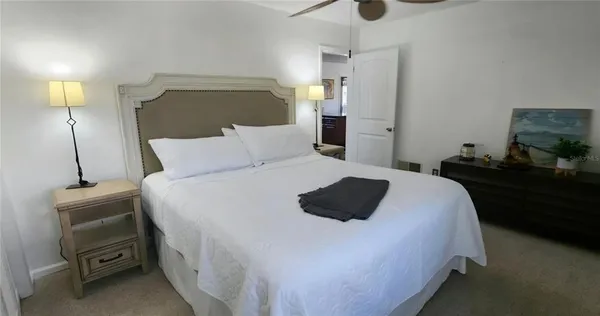 a bedroom with a bed and lamp