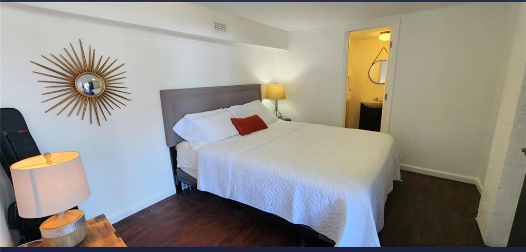 7 Bass Street Panacea, FL 32346 - Photo 9 of 11 a bedroom with a bed and painting on the wall