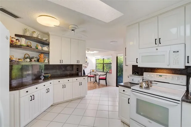 a kitchen with granite countertop a sink and cabinets
