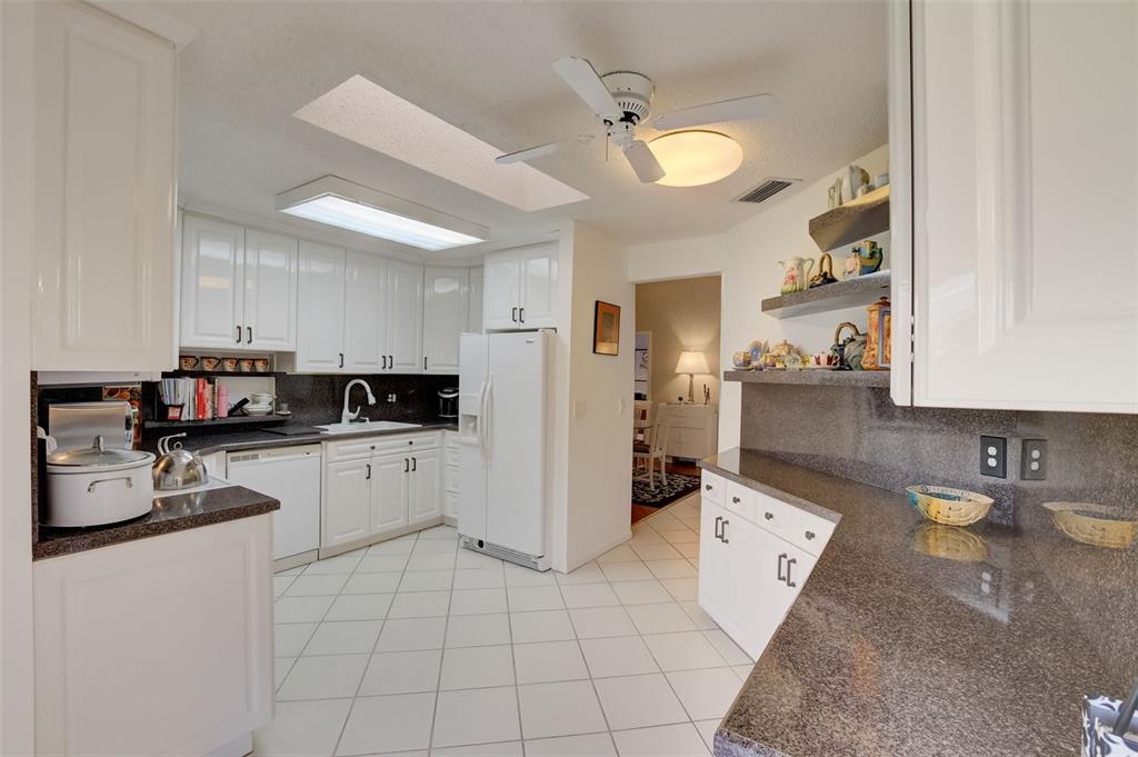5051 Pine Drive Boynton Beach, FL 33437 - Photo 16 of 40 a kitchen with a sink and cabinets