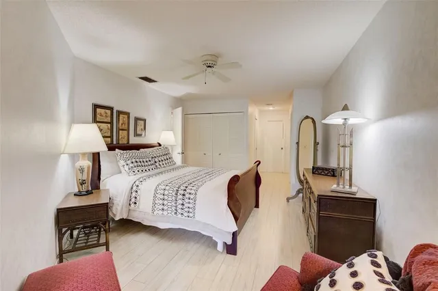 a bedroom with a bed and a lamp