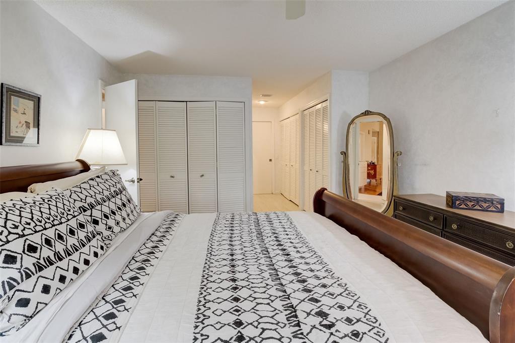 5051 Pine Drive Boynton Beach, FL 33437 - Photo 22 of 40 a bedroom with a bed and a lamp