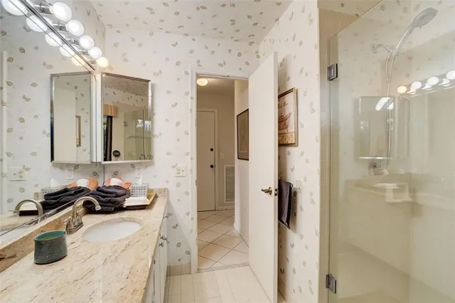 a bathroom with a tub sink and mirror