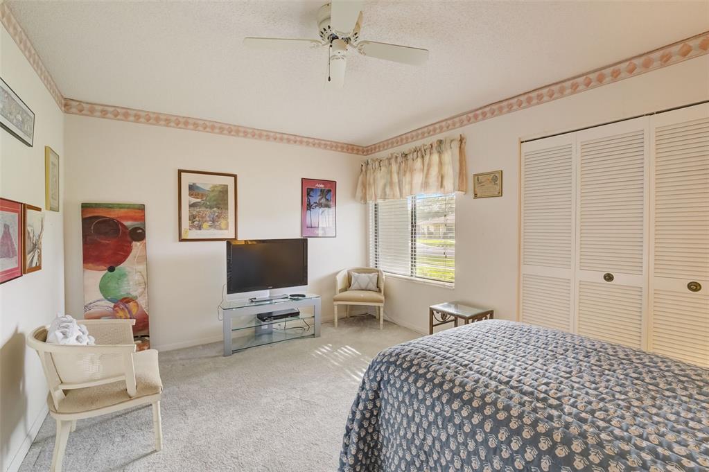 5051 Pine Drive Boynton Beach, FL 33437 - Photo 28 of 40 a bedroom with a bed and wooden floor