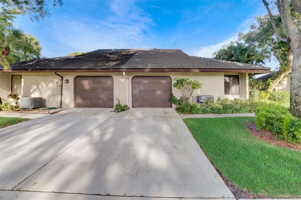 5051 Pine Drive Boynton Beach, FL 33437 - Photo 3 of 40 front view of a house with a yard