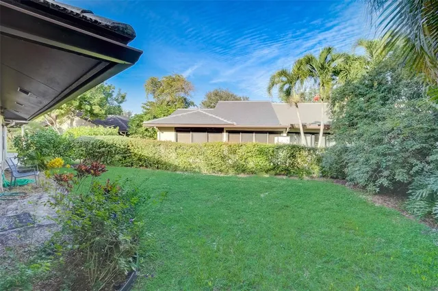 a view of a backyard with plants and a small yard