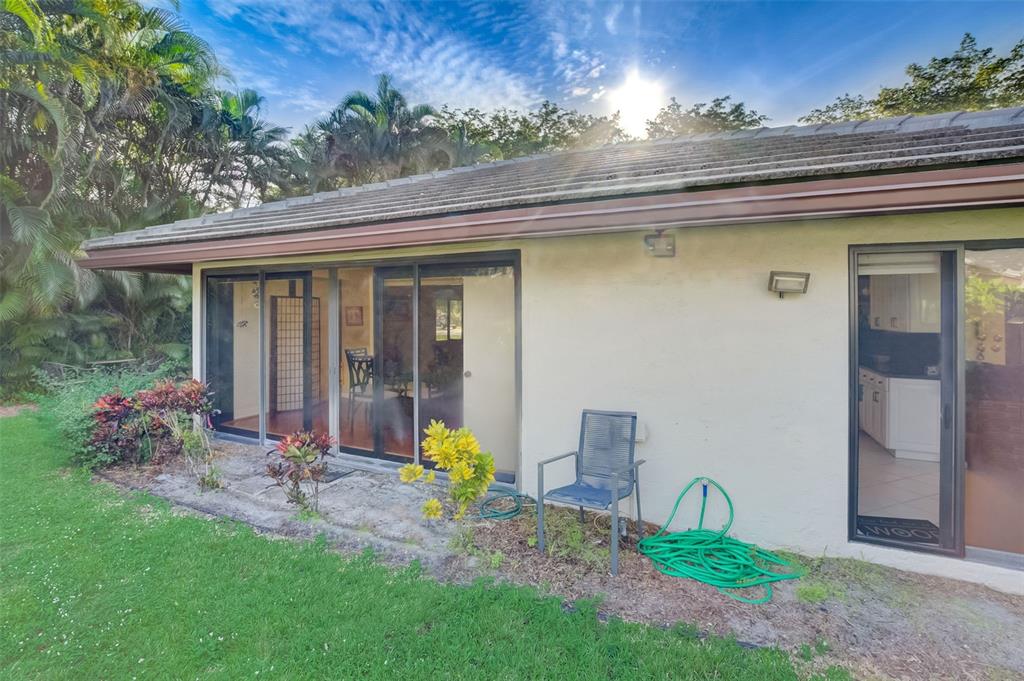 5051 Pine Drive Boynton Beach, FL 33437 - Photo 36 of 40 a view of a chair and table in backyard of the house
