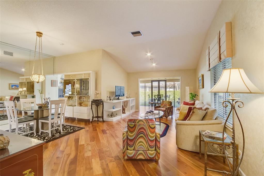 5051 Pine Drive Boynton Beach, FL 33437 - Photo 4 of 40 a living room with furniture large window and chandelier