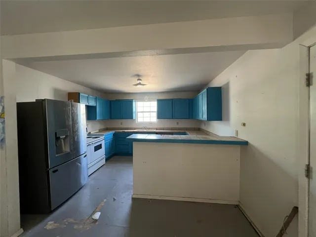 a kitchen with stainless steel appliances a refrigerator and a stove