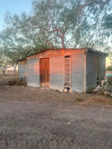 a backyard of a house with garage and outdoor seating