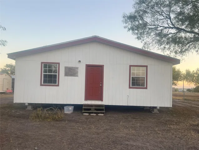 a view of a house with a backyard