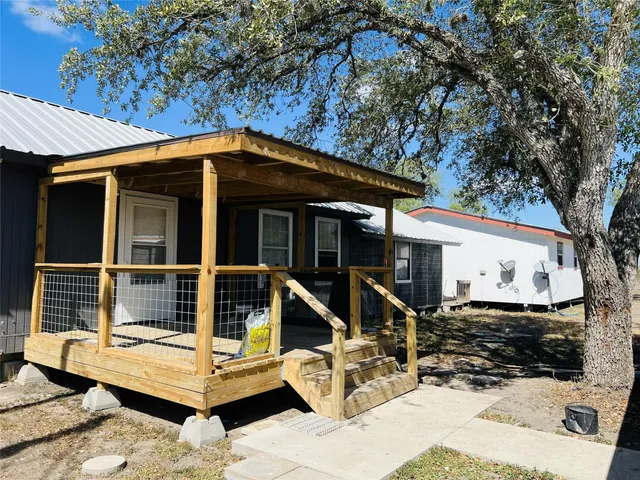 a front view of a house with a sitting area