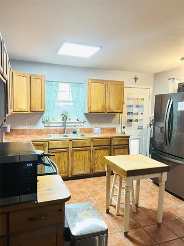 a kitchen with a sink cabinets and window