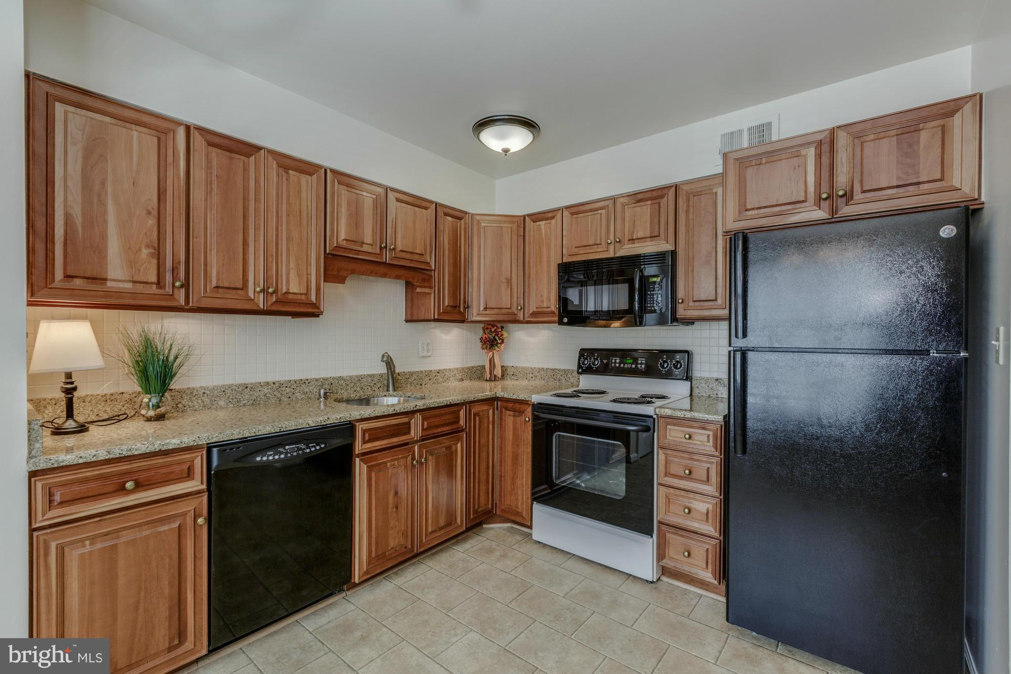 8321 Garfield Court Springfield, VA 22152 - Photo 8 of 30 Kitchen with cherry cabinets and granite counters