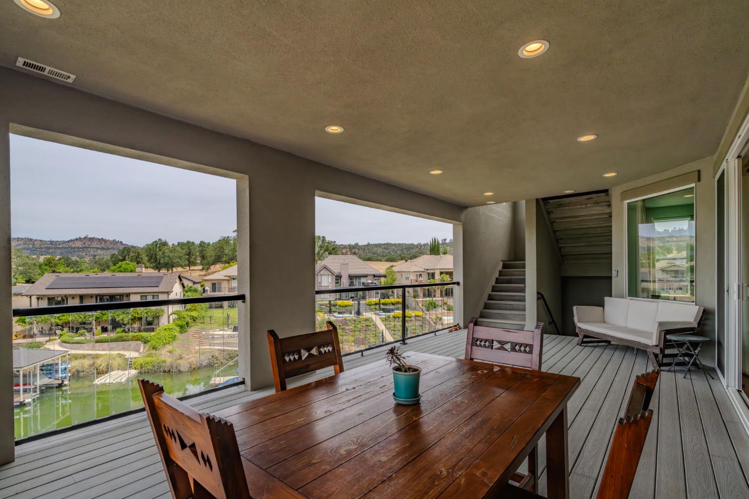 6066 Bluff View Road Copperopolis, CA 95228 - Photo 67 of 96 a dining room with wooden floor glass table and chairs