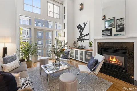 a living room with furniture a table and a fireplace