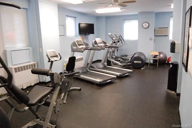 a room with gym equipment and a flat screen tv