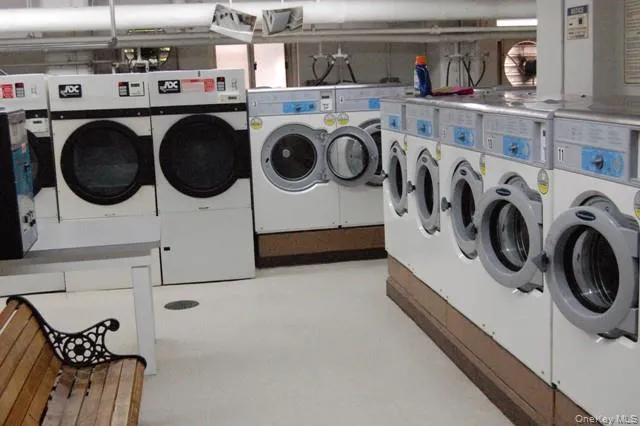 a utility room with dryer washer and other items